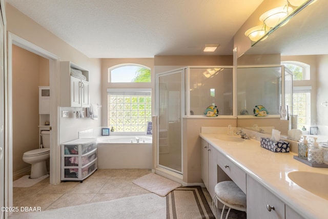 bathroom with a shower stall, a bath, a sink, and plenty of natural light