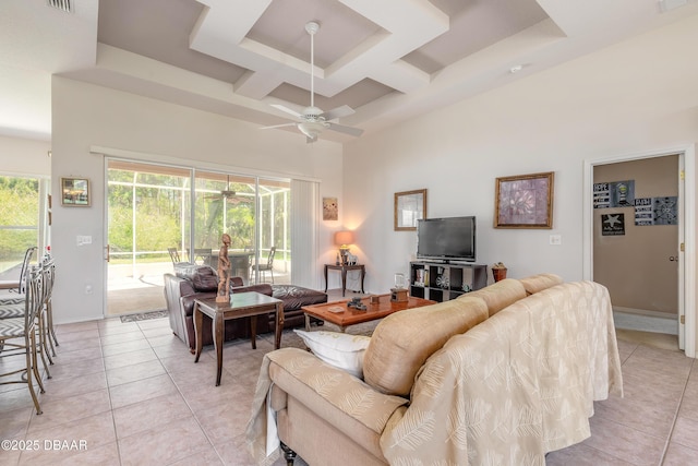living room featuring coffered ceiling, a high ceiling, ceiling fan, and light tile patterned flooring