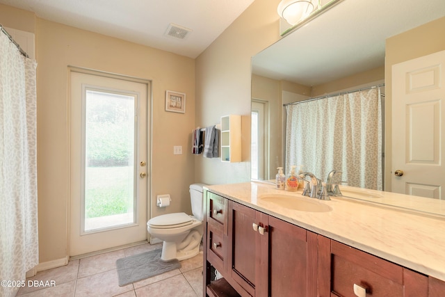 bathroom with tile patterned floors, vanity, visible vents, and toilet