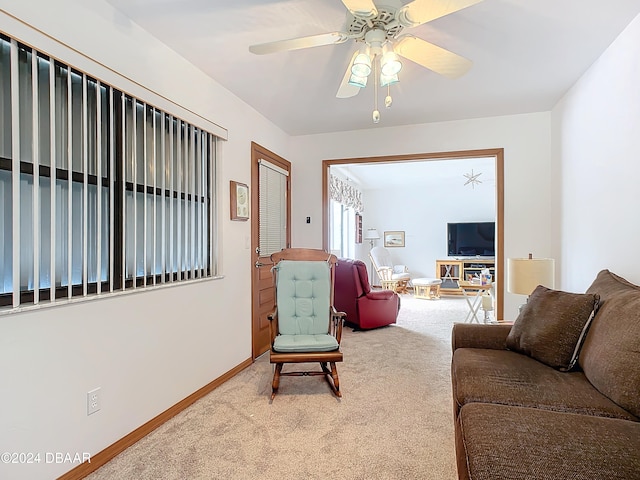 living room featuring light colored carpet and ceiling fan