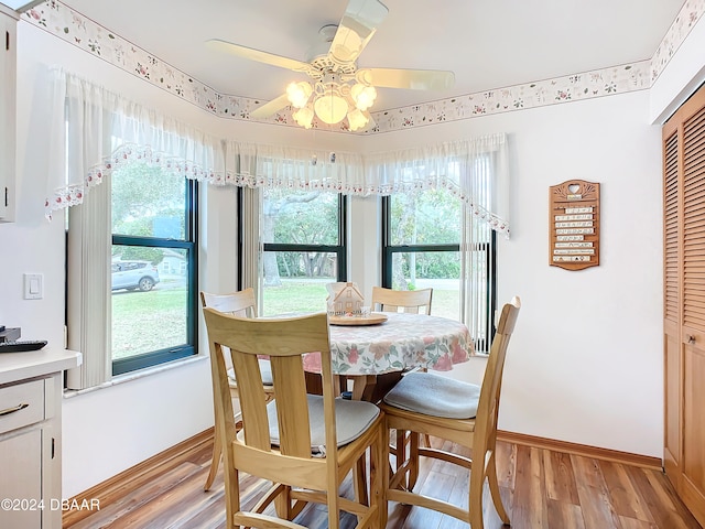 dining room with light hardwood / wood-style flooring, a wealth of natural light, and ceiling fan