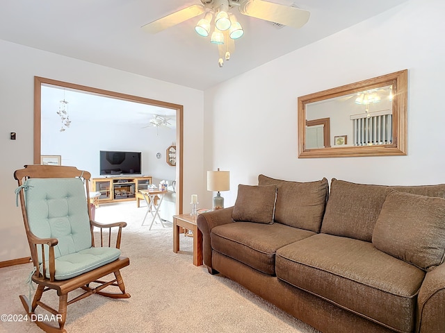 living room with ceiling fan and light colored carpet