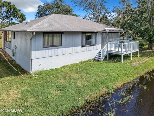 view of front of property with a front lawn and a wooden deck