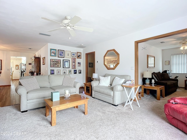 carpeted living room featuring ceiling fan