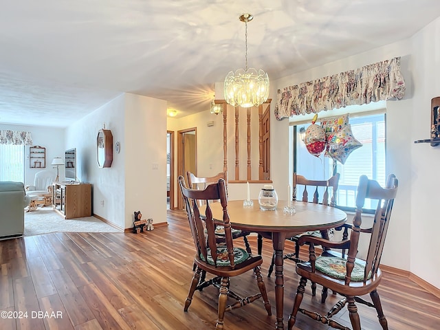 dining room with a notable chandelier and hardwood / wood-style flooring