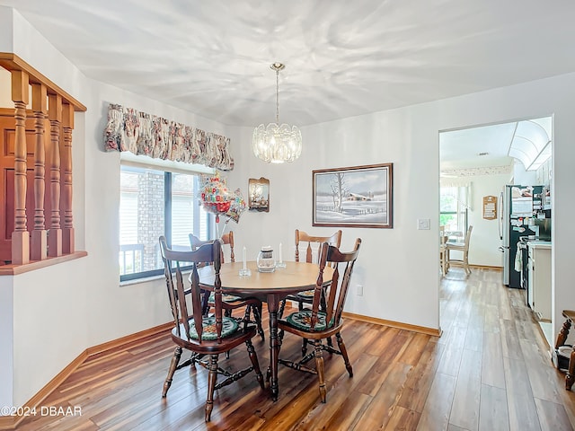 dining room with a notable chandelier and wood-type flooring