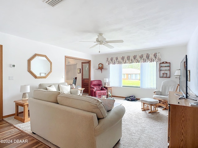 living room with wood-type flooring and ceiling fan