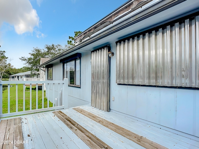 wooden terrace with a yard