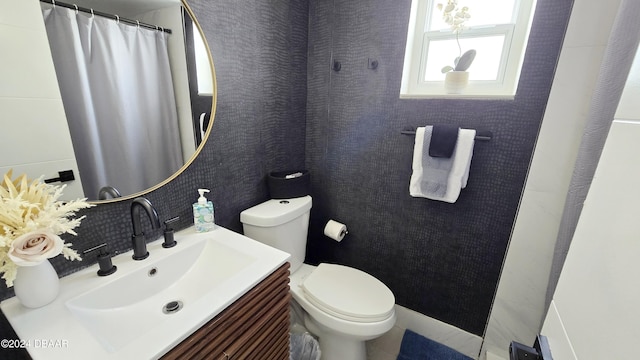 219 S Atlantic Ave Unit 206, Daytona Beach, FL 32118 - bathroom with toilet, vanity, and a shower with curtain
