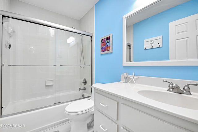 full bathroom featuring vanity, toilet, and combined bath / shower with glass door