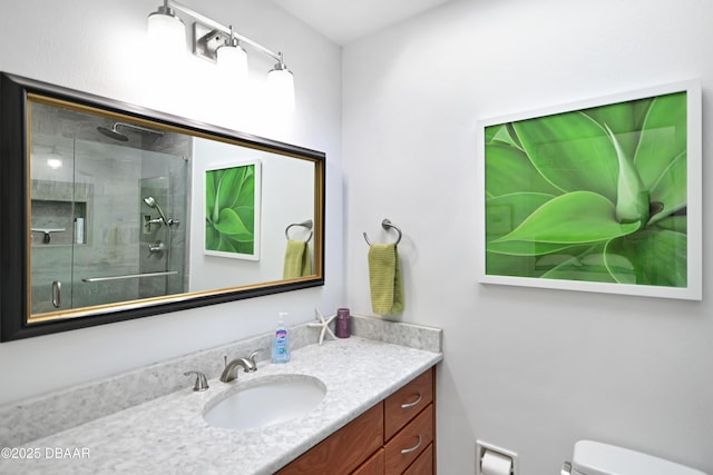 bathroom with vanity, an enclosed shower, and toilet