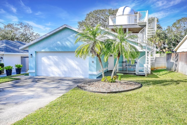 view of front of house featuring a garage and a front lawn