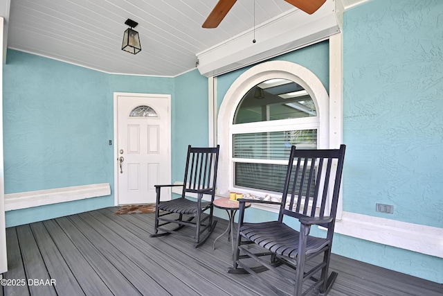 doorway to property with a porch and ceiling fan