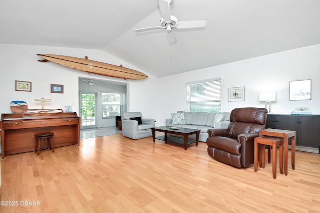 living room featuring lofted ceiling, ceiling fan, and light hardwood / wood-style flooring