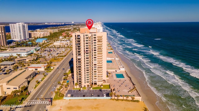 birds eye view of property with a water view and a view of the beach