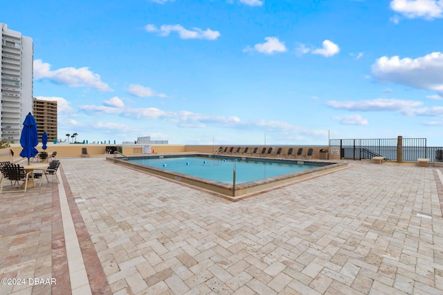 view of swimming pool with a patio