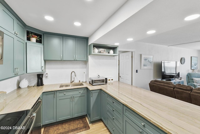 kitchen featuring green cabinetry, butcher block counters, and sink