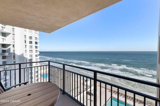 balcony featuring a water view and a view of the beach