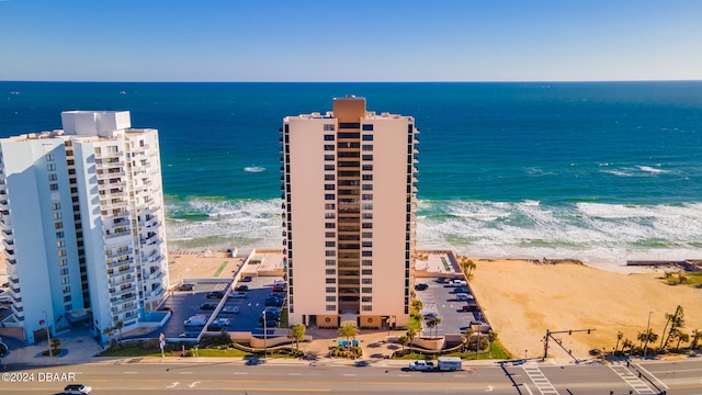 bird's eye view with a water view and a beach view