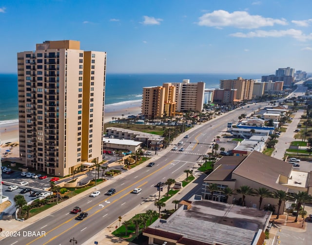 drone / aerial view featuring a water view and a beach view