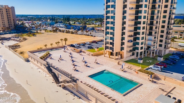 view of pool with a view of the beach and a water view