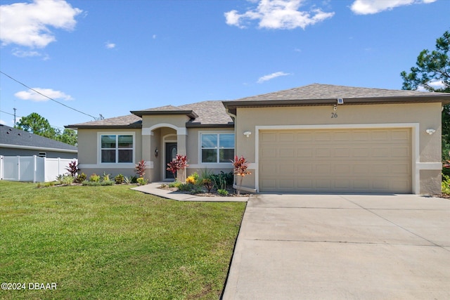 prairie-style home featuring a garage and a front yard