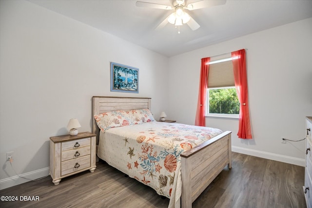 bedroom with dark hardwood / wood-style flooring and ceiling fan