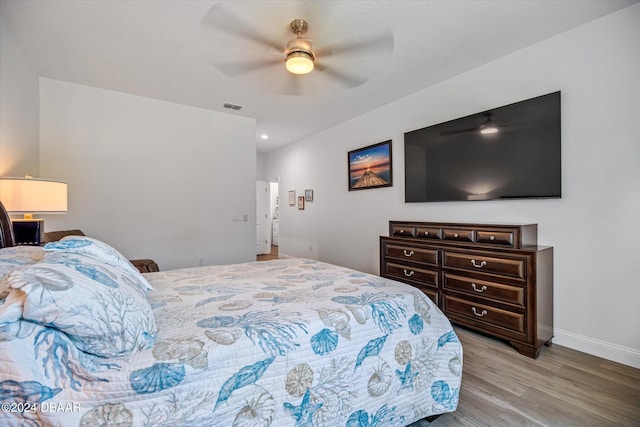 bedroom with light hardwood / wood-style flooring and ceiling fan