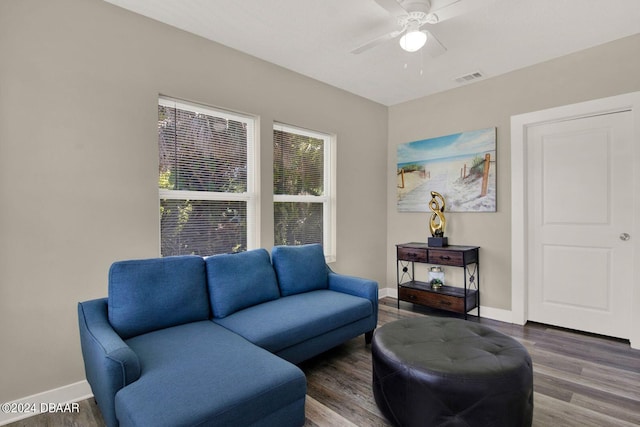 living room featuring ceiling fan and dark hardwood / wood-style flooring