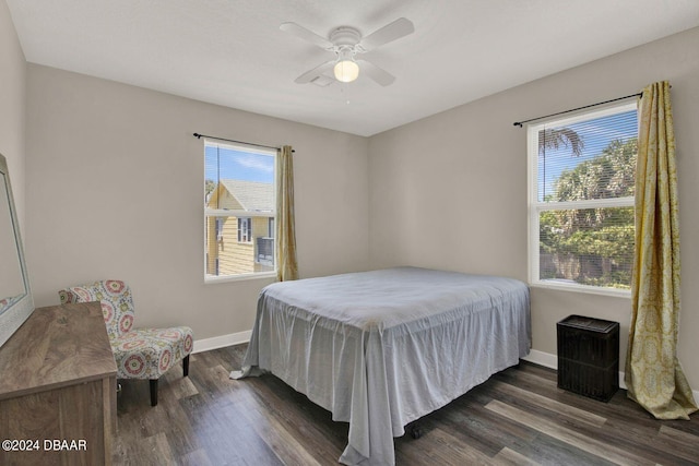 bedroom with ceiling fan and dark wood-type flooring