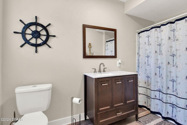 bathroom featuring hardwood / wood-style floors, vanity, toilet, and a shower with curtain