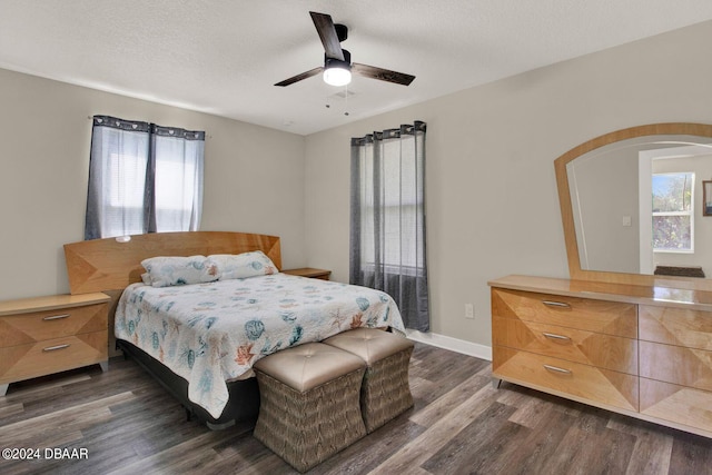 bedroom featuring a textured ceiling, ceiling fan, and dark hardwood / wood-style floors