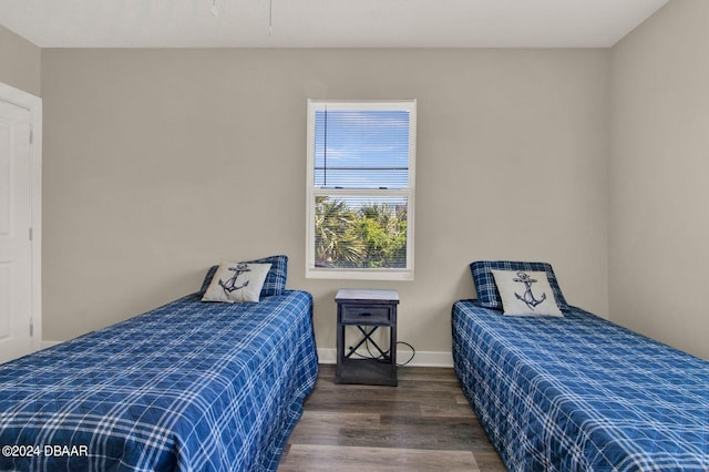 bedroom with dark wood-type flooring