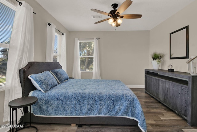 bedroom with ceiling fan and dark hardwood / wood-style floors