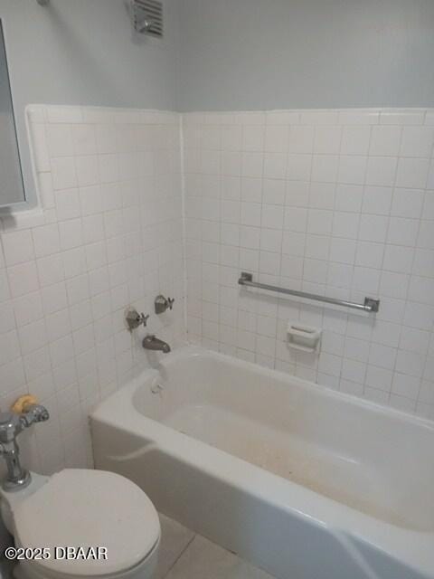 bathroom with toilet and tile patterned flooring