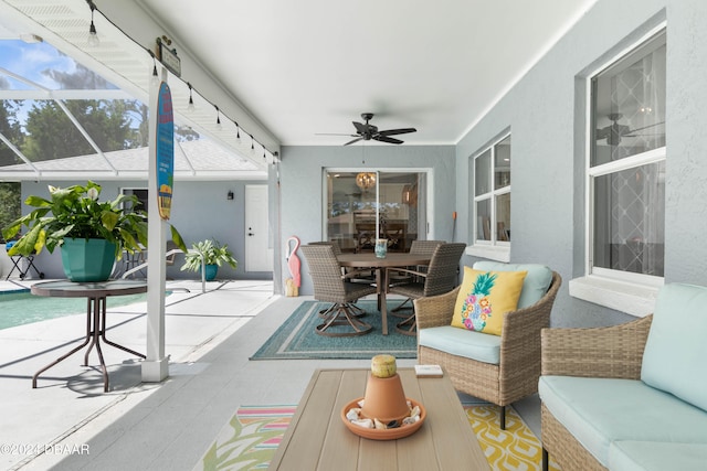 sunroom / solarium featuring ceiling fan