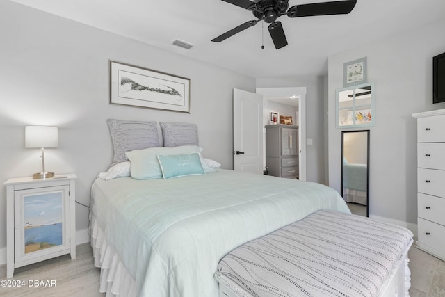 bedroom with ceiling fan and light hardwood / wood-style floors