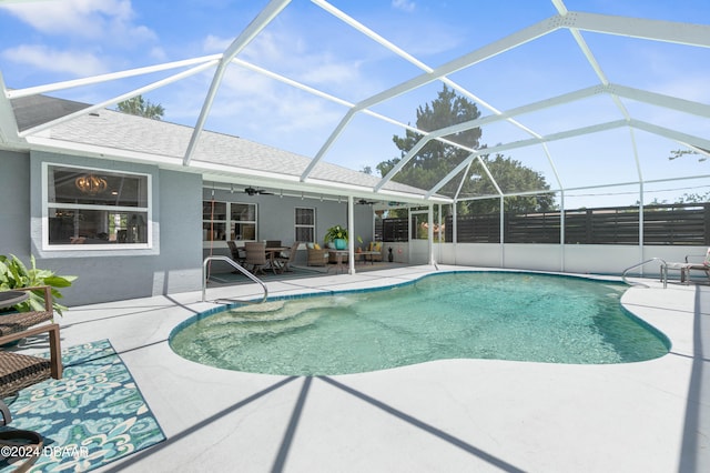 view of swimming pool featuring a patio, ceiling fan, and a lanai