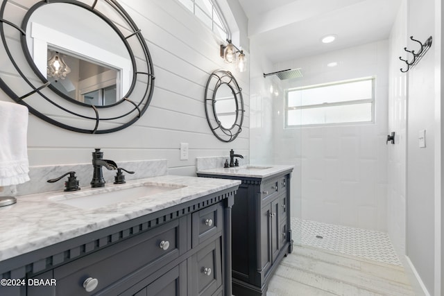 bathroom with a tile shower, wooden walls, and hardwood / wood-style flooring