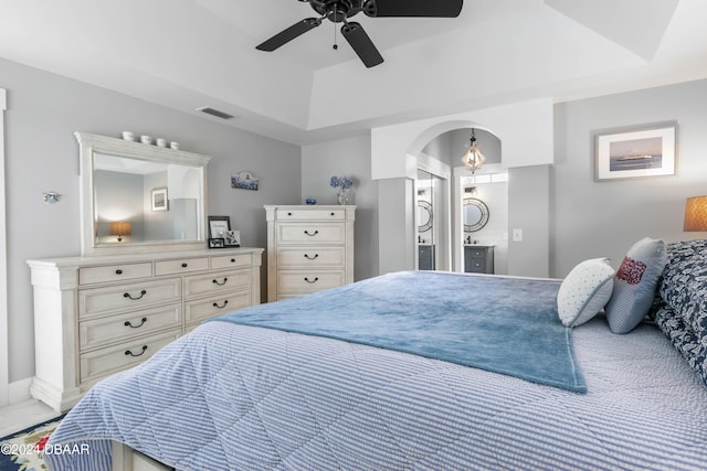 bedroom with a tray ceiling and ceiling fan