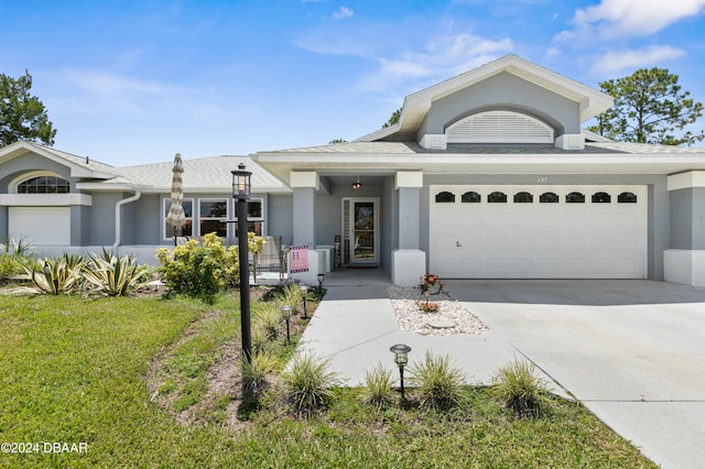 view of front of house with a front lawn and a garage