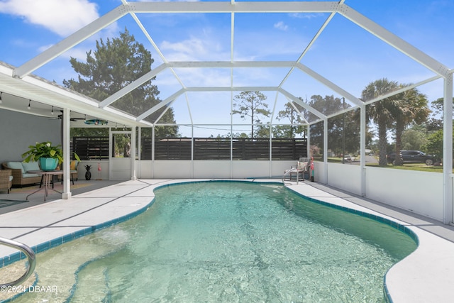 view of pool featuring a lanai, ceiling fan, and a patio area