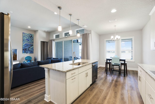 kitchen with stainless steel appliances, hanging light fixtures, sink, and dark hardwood / wood-style floors