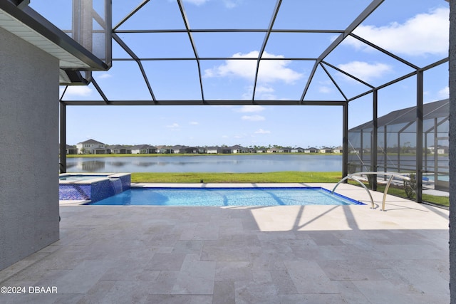 view of pool featuring glass enclosure, a water view, a patio, and an in ground hot tub