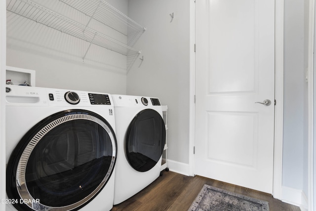 laundry room featuring dark hardwood / wood-style flooring and washing machine and clothes dryer