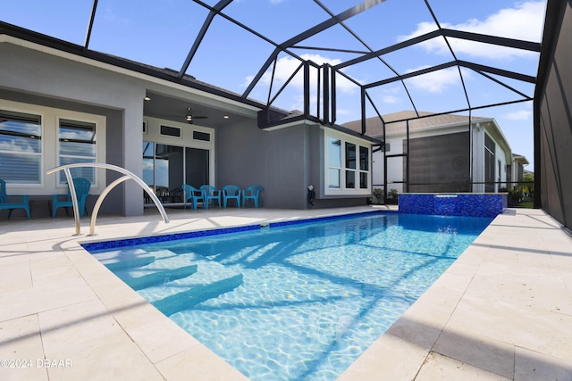 view of swimming pool featuring ceiling fan, a patio, and a lanai