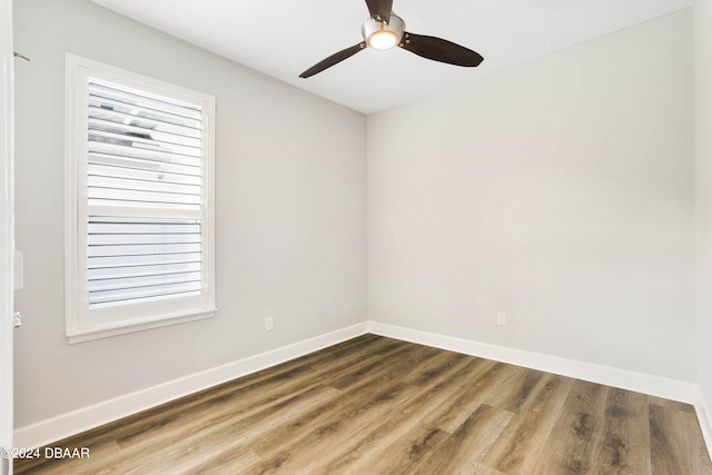 empty room with ceiling fan, hardwood / wood-style floors, and a healthy amount of sunlight