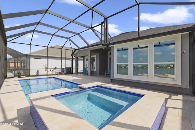 view of pool featuring glass enclosure and a patio area