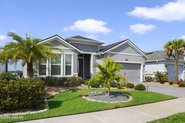 view of front of house with a garage and a front yard