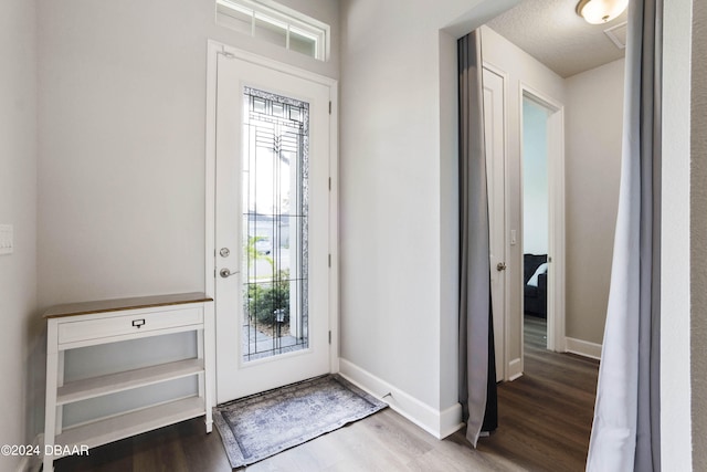 entrance foyer with wood-type flooring and a textured ceiling